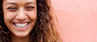 smiling woman peach background