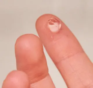 Close up image of a topical gel on persons finger.
