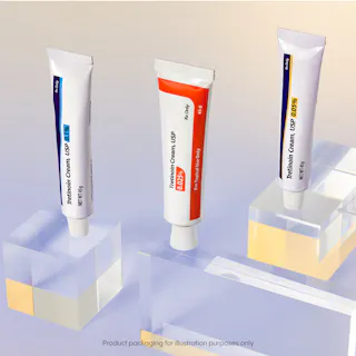 Three tubes of Tretinoin Cream USP 0.05% displayed upright on clear acrylic blocks against a gradient background. Text at the bottom says, 