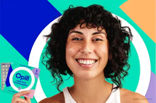 Person holding Opill daily oral contraceptive package, smiling against a colorful geometric background.