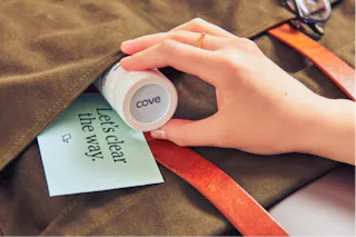 Hand placing a bottle labeled 