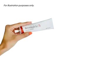 Hand holding a tube of Metronidazole Gel, 1%.