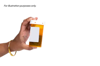 A hand holding an amber prescription pill bottle with a blank white label against a plain background.