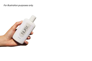 Hand holding a white bottle labeled 