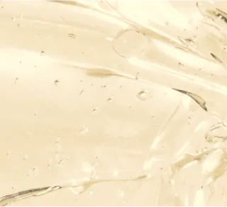 Close-up of a smooth, translucent gel infused with tretinoin cream, featuring scattered air bubbles on a light background.